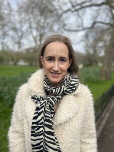 Photo of Sophie Kinsella in the park in a coat and scarf